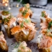 Mini jacket potatoes with hot smoked salmon, sour cream and chives